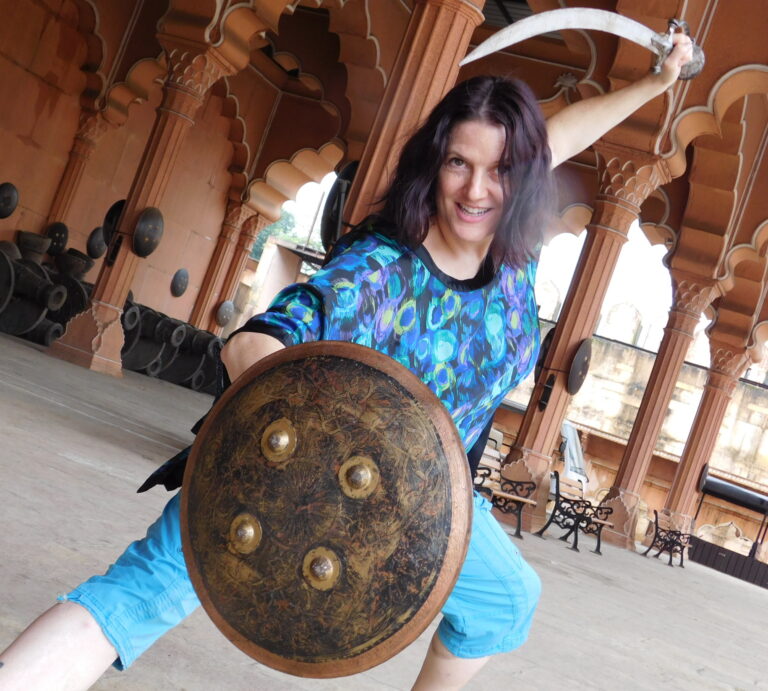 Kim at Nitin Desai's Bollywood Studio in India posing as warrior, reflecting strength and movement in her bodywork practice